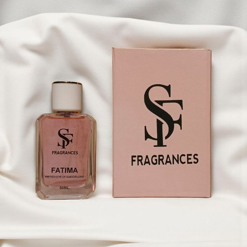 Perfume bottle and packaging with 'SF Fragrances' branding on a white fabric background
