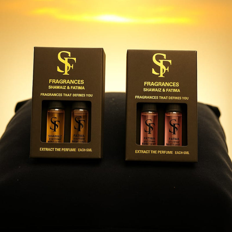 Two boxes of 'Fragrances Shahnaz & Fatima' on a dark surface with a warm glow.